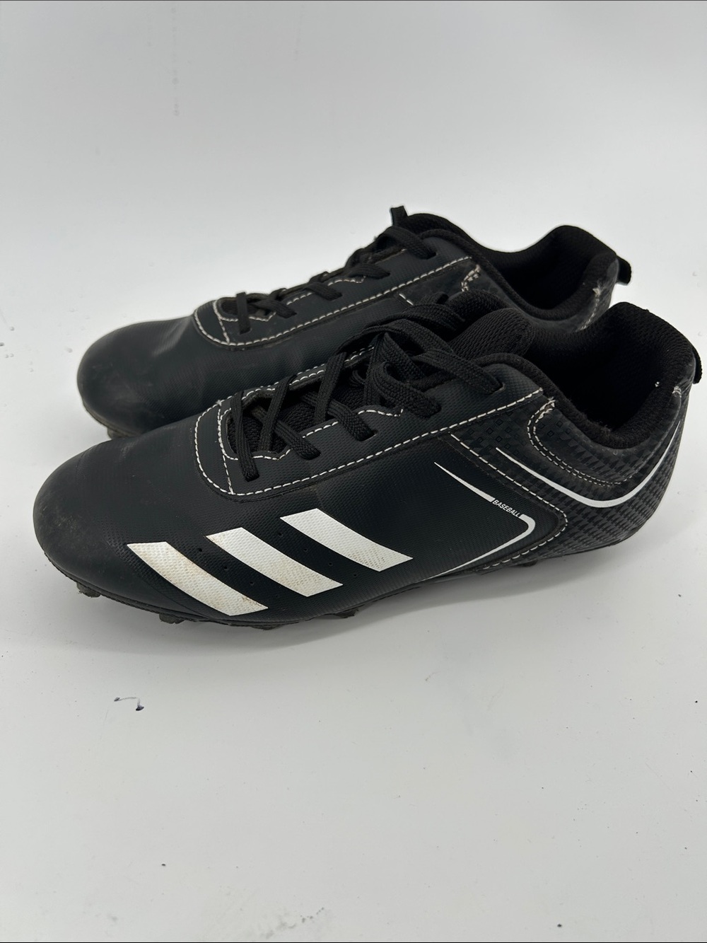 Adidas Rundown baseball cleats with white stripes. Kids boys size 2.5